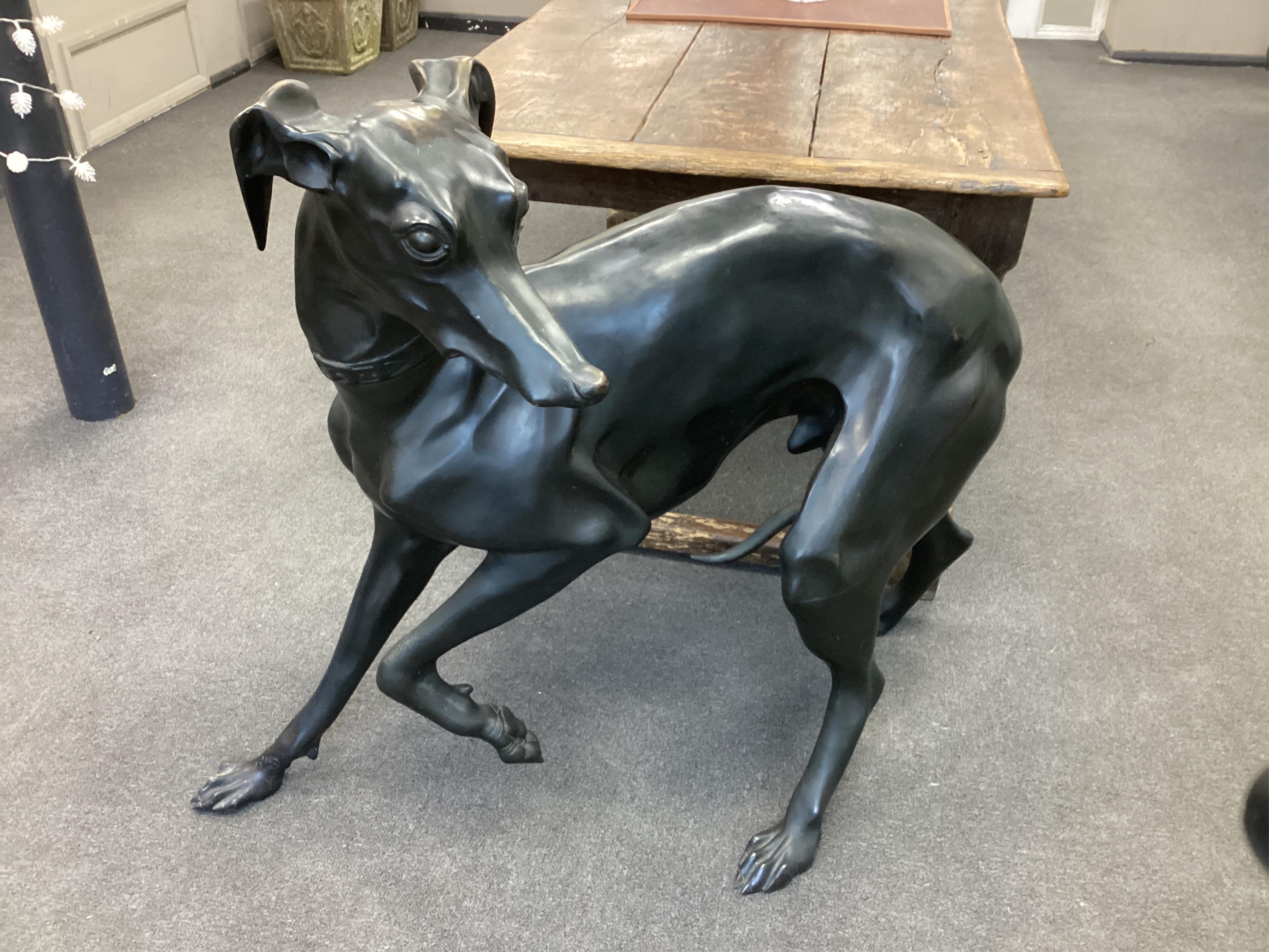 After P.J.Mene a life size dark patinated bronze of a standing greyhound, length 115cm, height 97cm. Condition - good